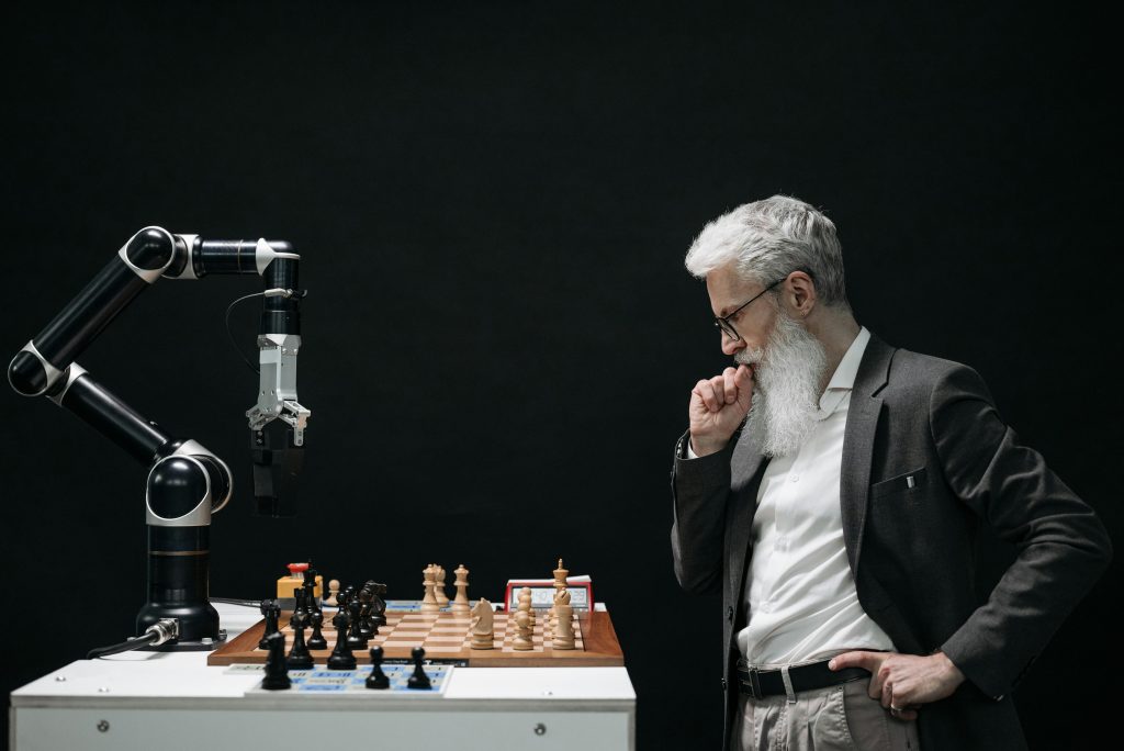 Elderly man thinking while looking at a chessboard